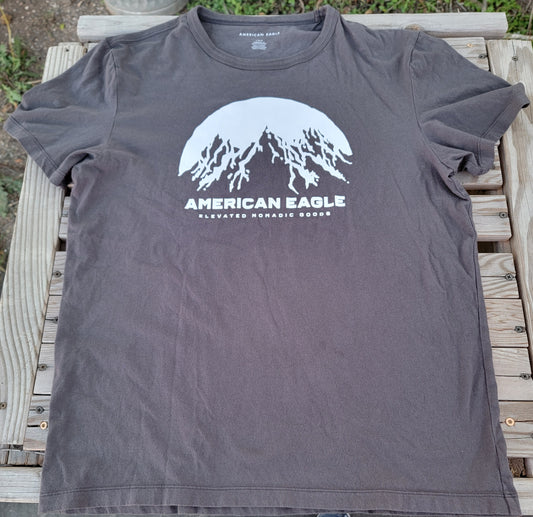 American Eagle large t-shirt 
brand new grey and white eagle shirt with the words elevated nomadic goods. t-shirt is on new condition.